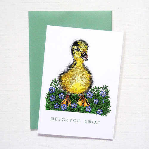 Ilustrowana Kartka Wielkanocna z Kaczuszką i wiosennymi kwiatami oraz delikatnymi złotymi detalami i napisem Wesołych Świąt.