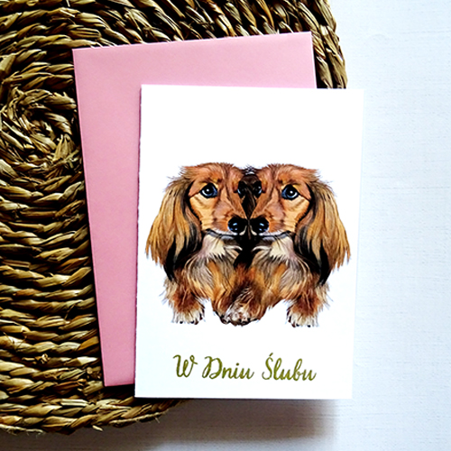 Kartka Ślubna z zakochanymi Jamnikami wraz ze złotym napisem W Dniu Ślubu.