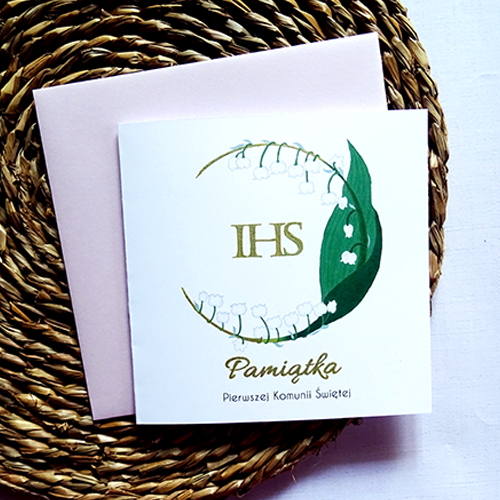Kartka Komunijna z Konwalią i napisem IHS w środku oraz delikatnymi złotymi detalami na gałązce tworzącej wianek, wyjątkowa Pamiątka Pierwszej Komunii Świętej.